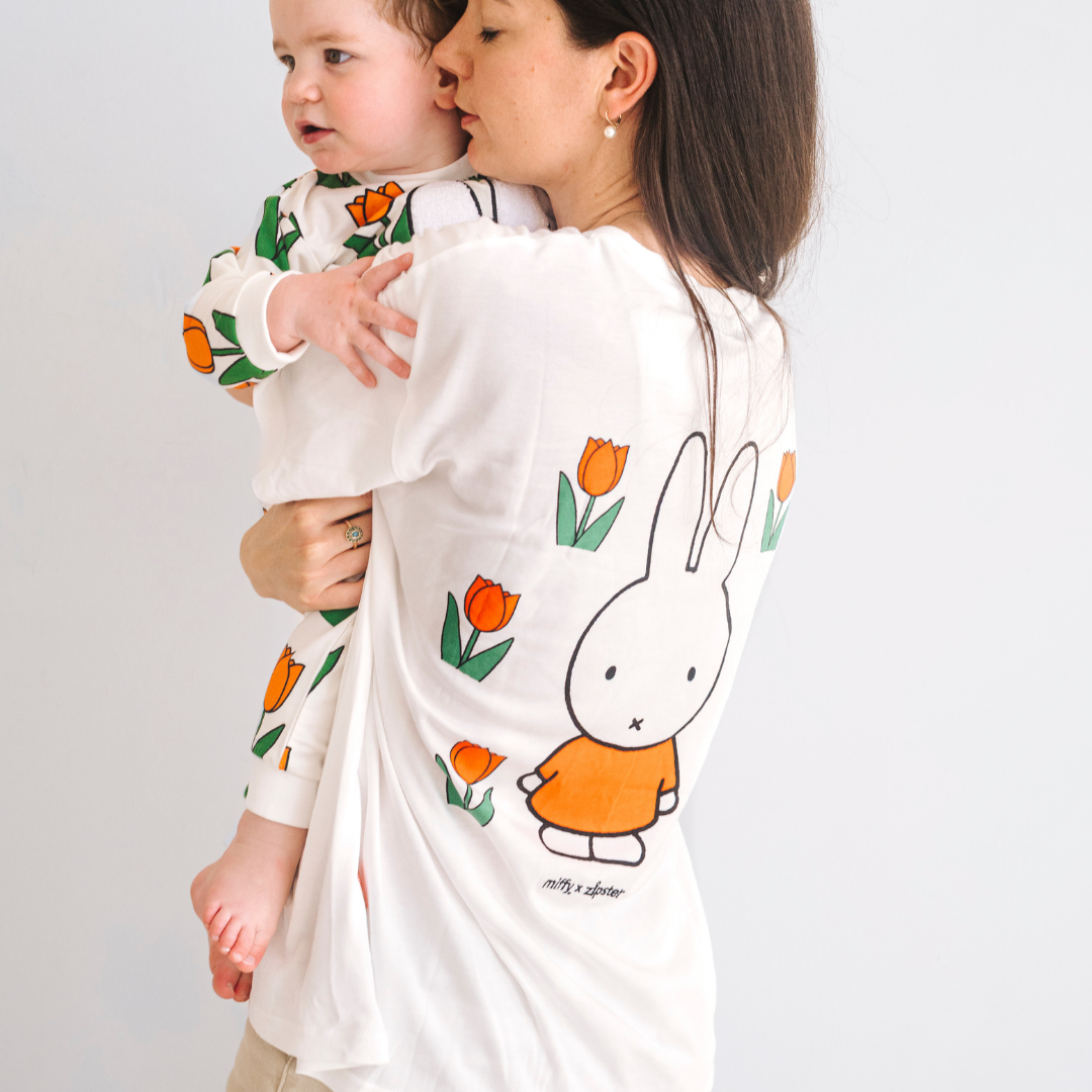 Woman wearing the Miffy white breastfeeding T-shirt with embroidered tulip and nursing zips